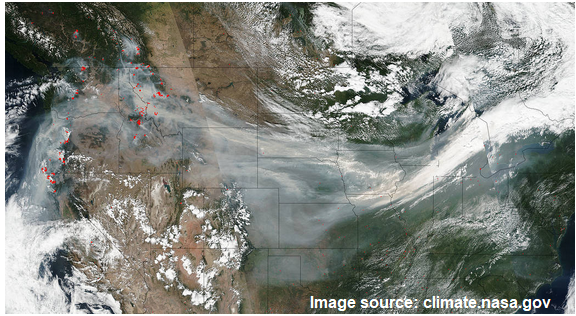 An image from a satelllie showing smoke transport from the September 2017 wildfires in the Pacific Northwest. Hazy brown smoke is being carried by the jet stream from coast to coast across the United States.